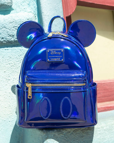 671803459731 - 707 Street Exclusive - Loungefly Disney Mickey Mouse Holographic Series Mini Backpack - Sapphire - Blue Holographic Backpack in front of Blue Wall at DIsneyland