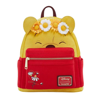 The front view of the entire yellow and red mini backpack, displaying Winnie the Pooh's face with a floral crown, a red front pocket with floral embroidery, and the Disney Loungefly logo.