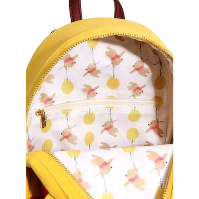 Another inside view of the yellow mini backpack, showcasing the same pattern of Winnie the Pooh floating with yellow balloons and a small zippered pocket.