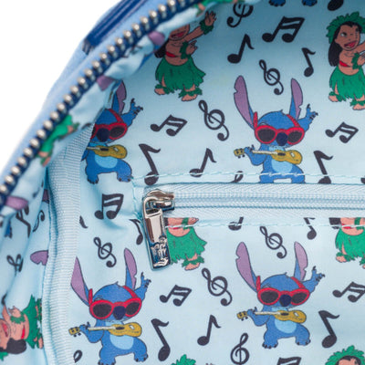 The inside lining of the backpack is light blue with an all-over print of Stitch playing the ukulele and Lilo dancing, accented with musical notes, showcasing the fun and playful theme.