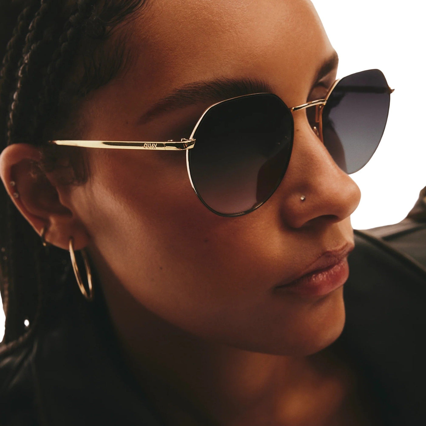 Model wearing Quay Women's Rooftop Round Sunglasses (Black Gold Frame/Smoke Lens) - right side profile zoomed in