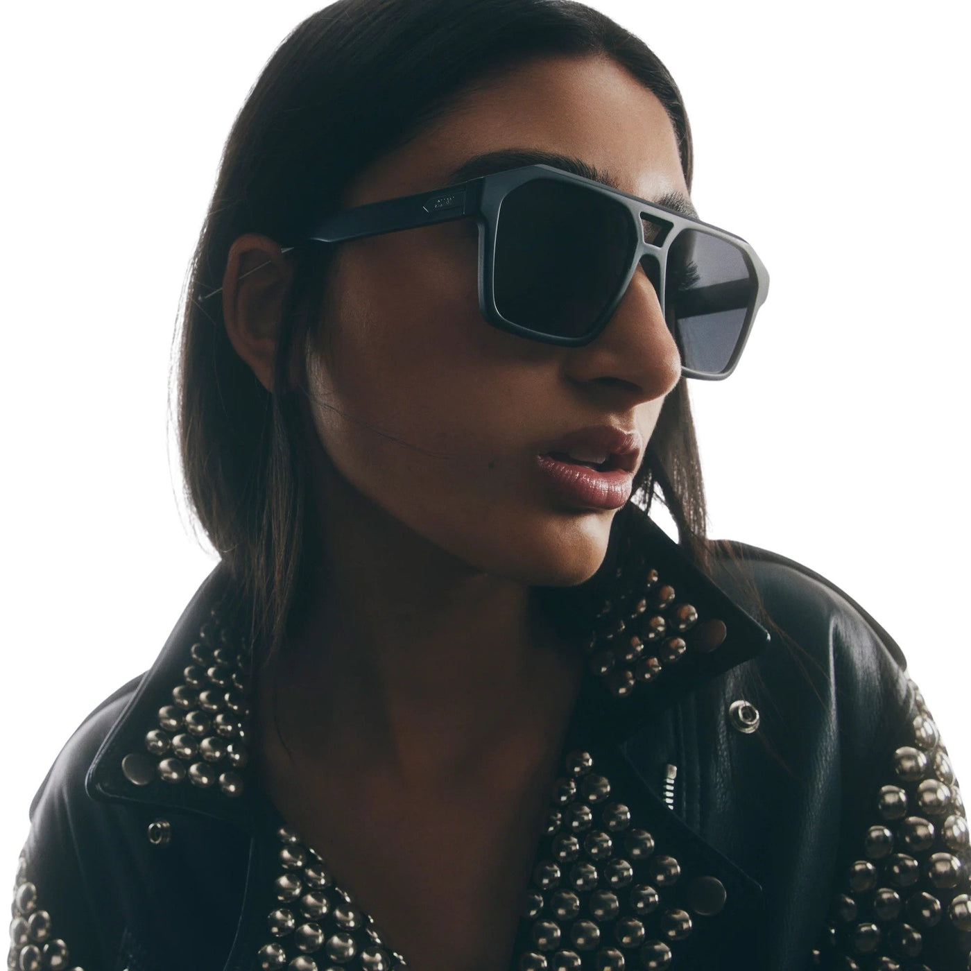 Model wearing Quay Women's Soundcheck Modern Aviator Sunglasses (Matte Black Frame/Black Polarized Lens) - right profile angle zoomed in