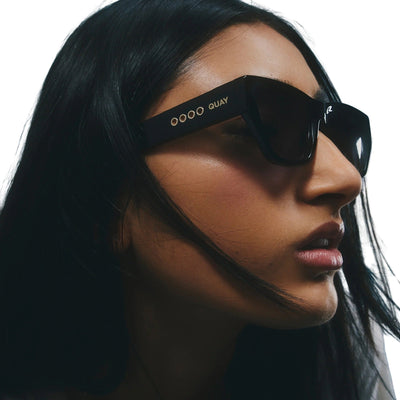 Model wearing Quay Women's No Apologies Angled Square Sunglasses (Black Frame/Smoke Lens) - zoomed in right profile
