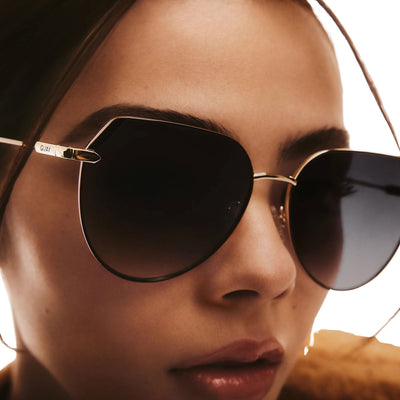 A close up of a model wearing Quay Women's Main Character Oversized Flat-Top Rounded Sunglasses - 3/4 view