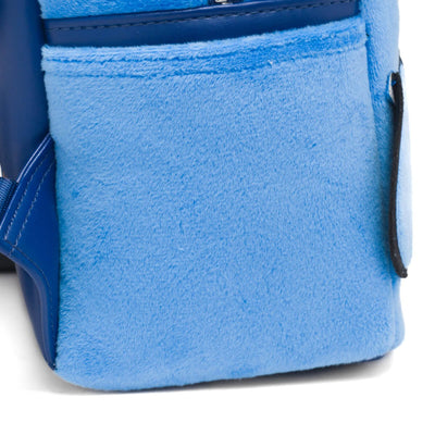 Detailed view of the side pocket on the mini backpack, made from blue plush material.