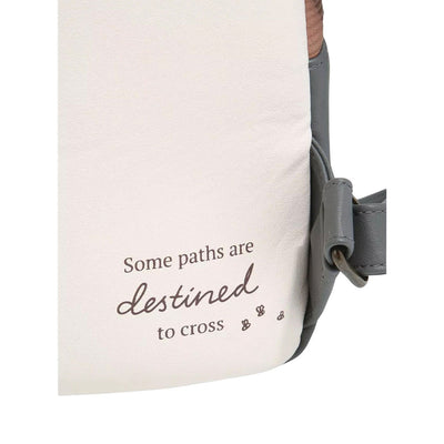 Close-up view of the side of a mini backpack showing the text "Some paths are destined to cross" with small footprints below the text.