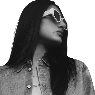Black & White photo of model wearing Quay Women's Hot Gossip Geometric Cat Eye Sunglasses (Bone Frame/Smoke Lens) - right profile angle