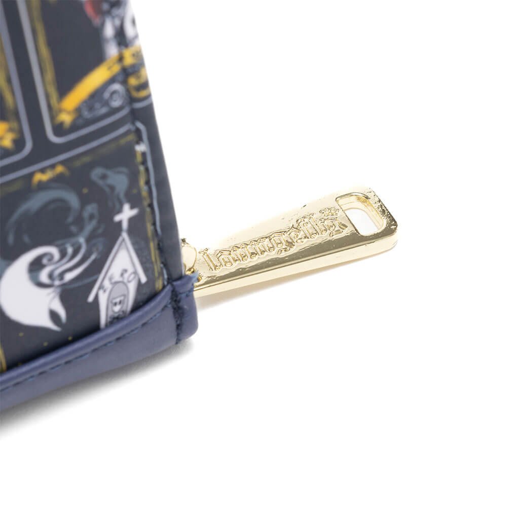 A close-up view of the gold zipper pull on the Loungefly Disney Nightmare Before Christmas Tarot Wallet, showcasing the engraved "Loungefly" logo and part of the tarot card print with character illustrations.