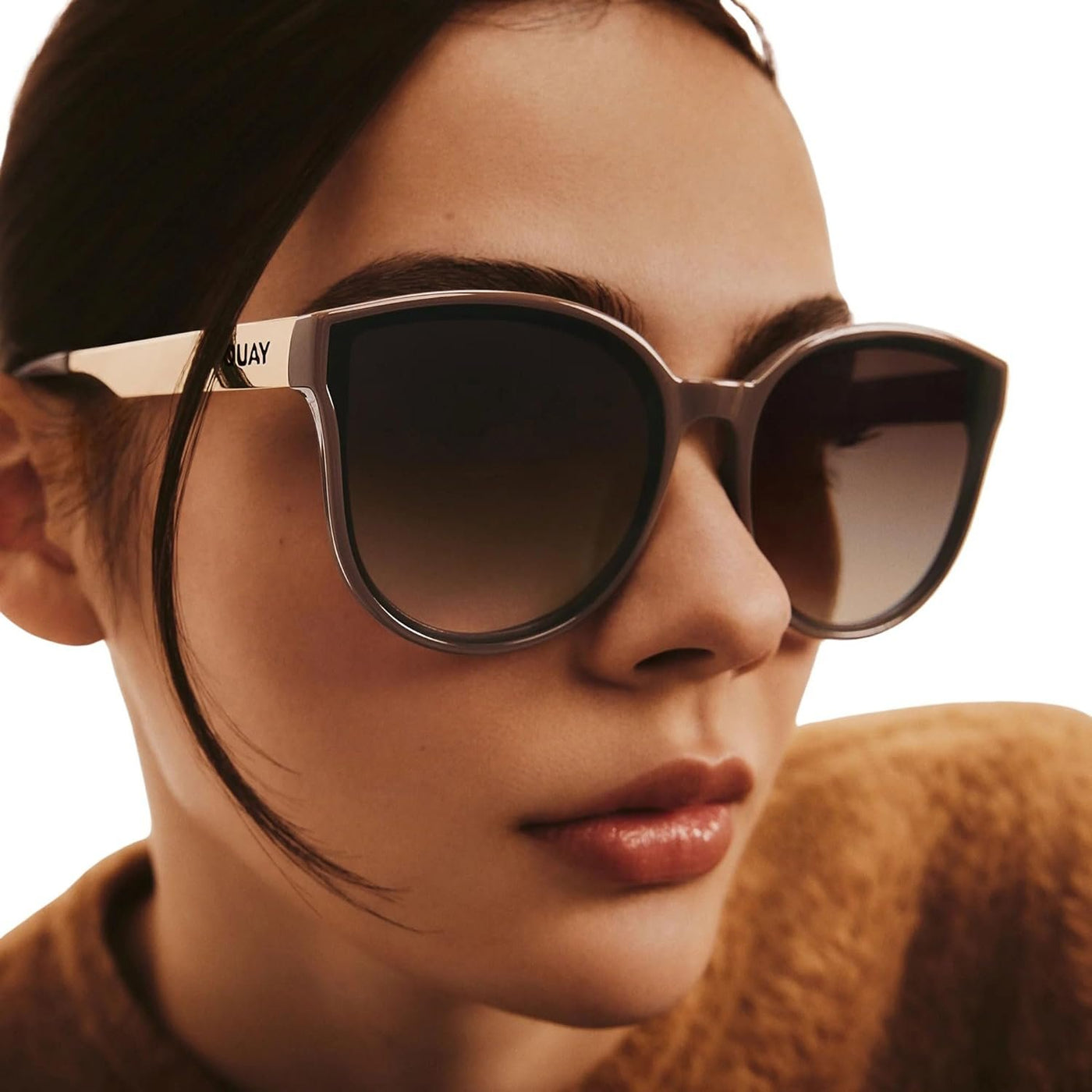 Model wearing Quay Women's Date Night Oversized Round Sunglasses (Doe Frame/Brown Lens) - 3/4 right angle
